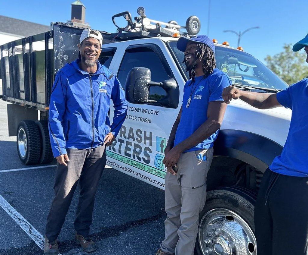 The Trash Porters crew beside their branded truck